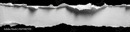 Ripped piece of white paper on a black background (1)