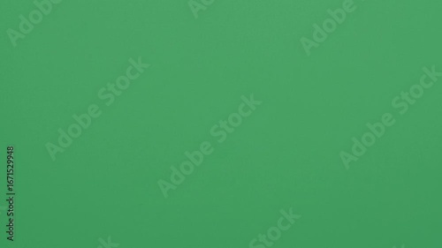 Stop motion animation of crumpled pape on a green background
