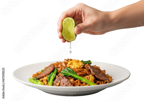 Adult hand squeezing vibrant lime wedge, juice drop falling onto Pad See Ew noodles with beef and gai lan on white plate, transparent background, dynamic fresh food concept