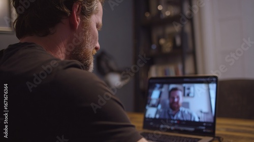 Man having online therapy session with psychologist using laptop