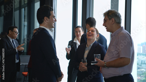 Business professionals networking and enjoying drinks at a corporate event