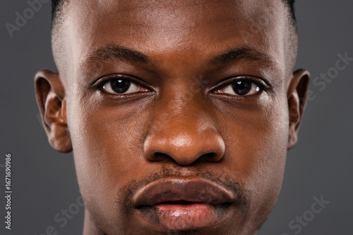 Close up portrait of African man face with eyes looking at camera showing strong expression and authentic detail