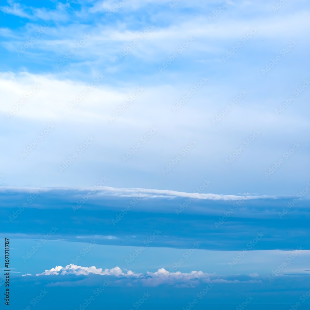 Fototapeta premium Layered clouds in a vast blue sky