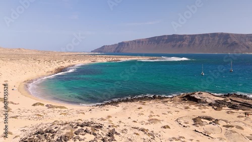 Aerial Drone Shot Flying Over Playa Francesa Beach And La Graciosa Island In The Canary Islands, Spain On A Bright Day.