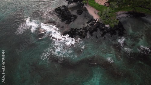 Aerial View of Rugged Hawaiian Shoreline with Lava Rocks and Turquoise Water