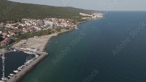 Wallpaper Mural Coastal view of a beach town by the sea. Aerial view of a beach town with colorful buildings, sandy shores, and crystal-clear waters. Torontodigital.ca