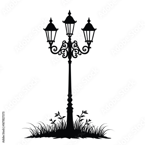 Black silhouette of a vintage triple lamp post with grass