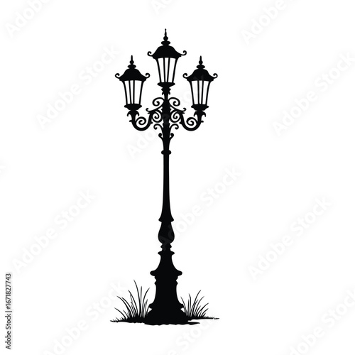 Black silhouette of a vintage triple lamp post with grass