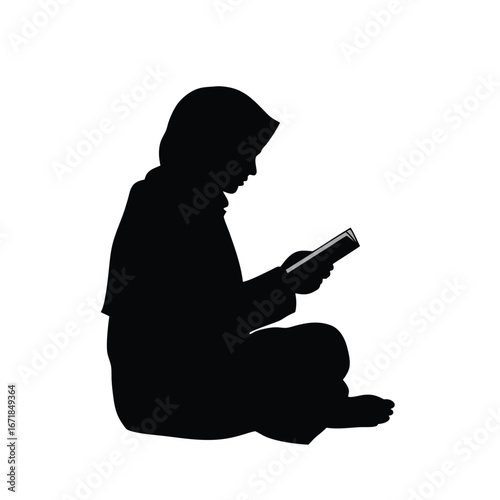 Silhouette of a person wearing a hijab reading a book