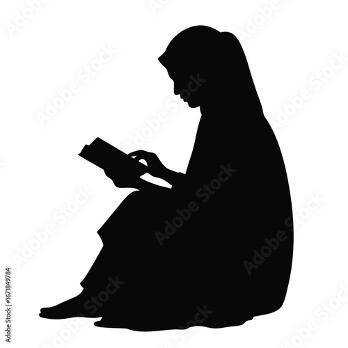 Silhouette of a woman wearing a hijab reading a book