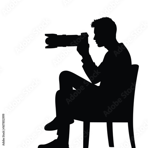 Black silhouette of a man sitting and holding a camera