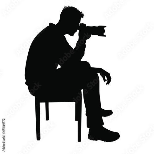 Silhouette of a man sitting on a chair taking a photo