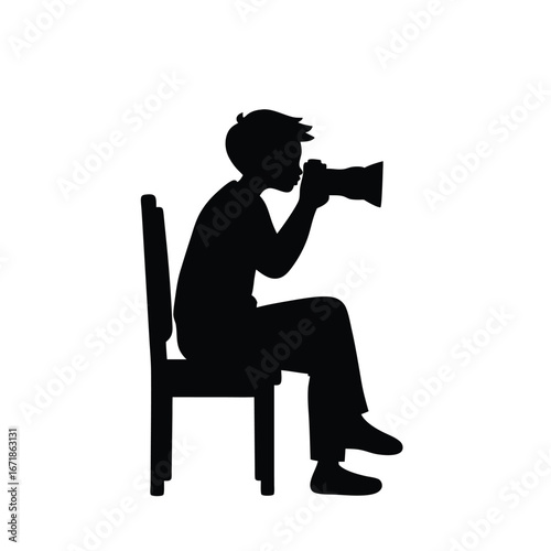 Silhouette of a person sitting on a chair taking a photo with a camera