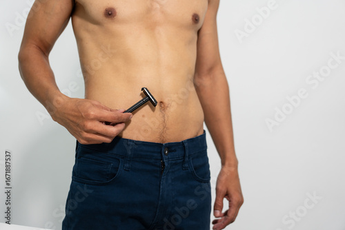 A modern man shaving his stomach hair with precision, highlighting personal grooming and hygiene. The concept reflects self-confidence, self-care, body positivity