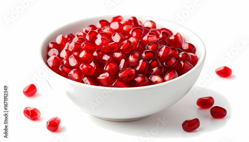 White bowl full of fresh juicy red pomegranate seed aril. Healthy fruit food isolated on white background. delicious and vibrant ingredient for healthy diet