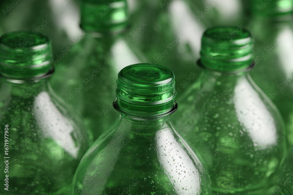Obraz premium Green plastic bottles with condensation droplets