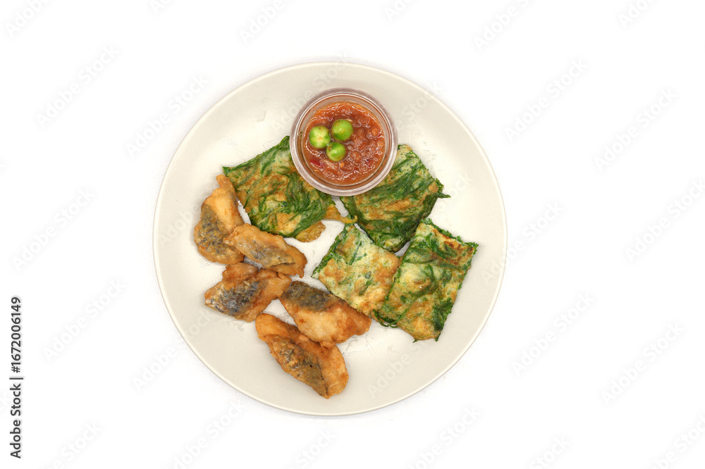 Fototapeta premium Deep-fried sea bass and cha-om leaves, battered and fried with shrimp paste and eggplant.