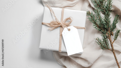 Christmas and New Year mockup of white gift box with blank tag on festive background and copy space, warm color tone.