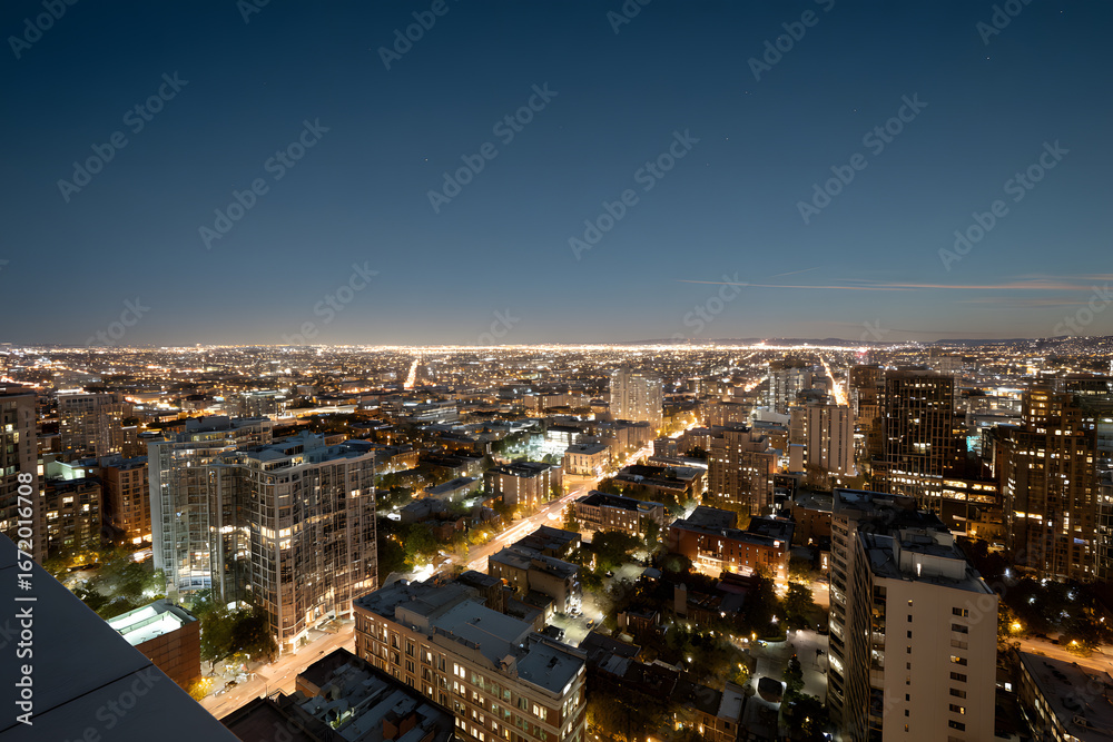 Fototapeta premium Vast urban cityscape illuminated by countless twinkling lights at twilight, representing modern development, economic growth, and vibrant city life