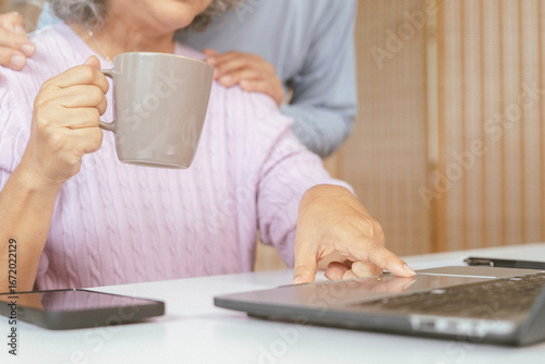 senior couple and documents with laptop for finance, budget planning or retirement annuity on sofa. Elderly man, woman or house with smile, computer or paperwork for pension fund or insurance
