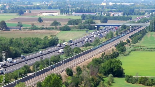 Aerial video of car and truck traffic on the Italian highway A1 also called the Autostrada del Sole between Reggio Emilia and Parma. Emilia Romgna,  Italy