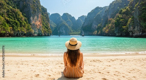 Woman Sitting on Sandy Beach Overlooking Turquoise Bay and Limestone Cliffs