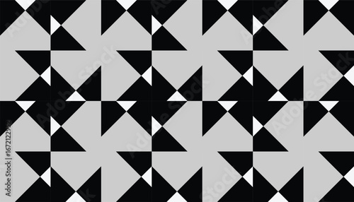 Abstract geometric seamless pattern with black and white triangular shapes forming a modern repetitive design on a gray background