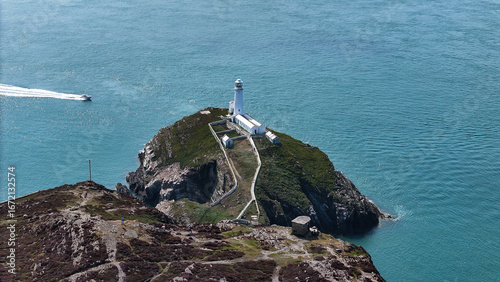 Aerial Photo of South Stack Lighthouse Anglesey Wales UK. The lighthouse acts as a waymark for coastal traffic and a landmark and orientation light for vessels crossing the Irish Sea.