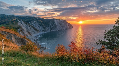 Dramatic coastal sunset over autumnal cliffs