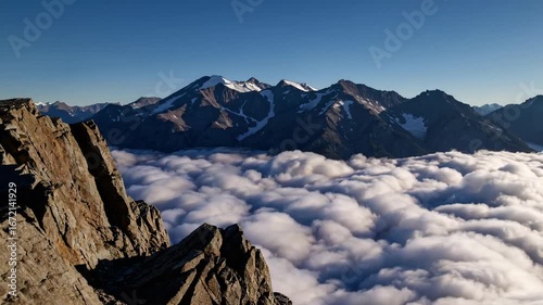 Stony observation point above phenomenon of clouds inverting amidst range of mountains