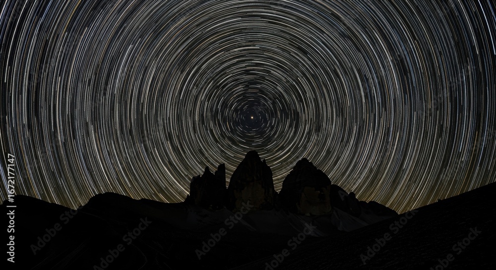 Fototapeta premium Star Trails Over Tre Cime di Lavaredo: A Night Sky Symphony