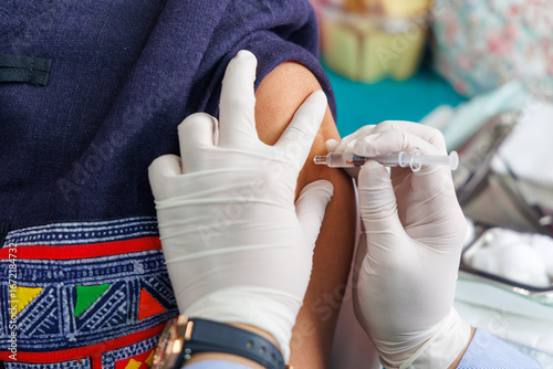 Get vaccinated against influenza. A Medical Professional Administering a Vaccine Shot to a Patient's Arm