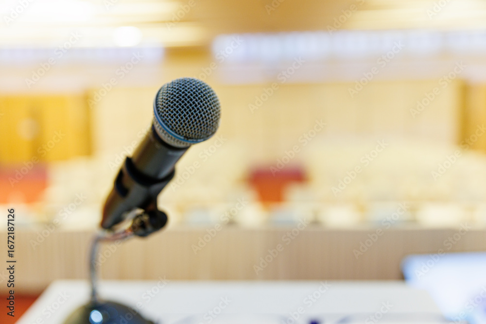 Fototapeta premium Microphone and Documents on a Podium in an Empty Conference Hall