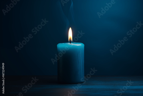 Blue candles lit separately on a dark blue background.