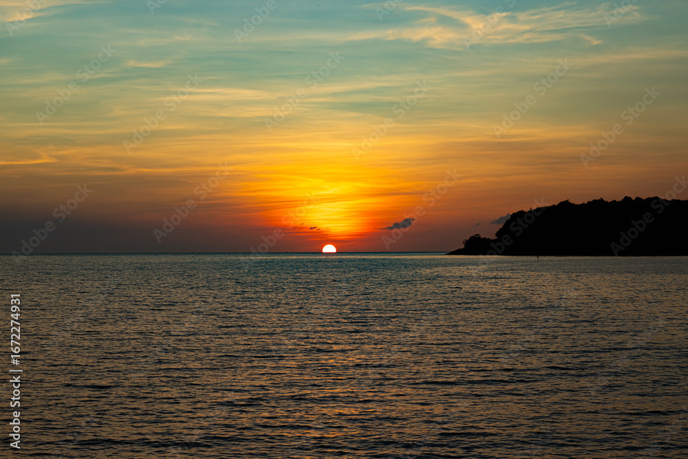 Naklejka premium Sun setting out on West Philippines Sea at resort in Bataan Philippines 2024 