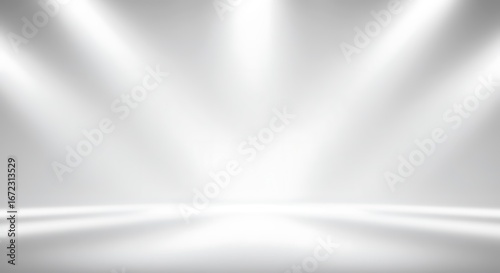 Abstract white and gray gradient background with soft spotlights shining down, creating a bright and clean studio effect.