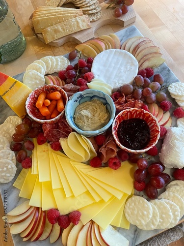 Gourmet Cheese and Charcuterie Board with Fresh Fruit and Crackers