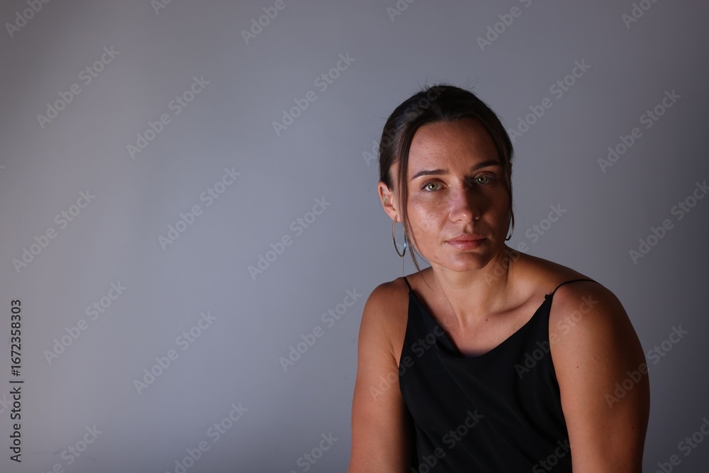 Fototapeta premium Portrait of beautiful woman on grey background. Space for text