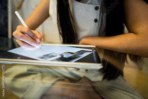 close up of the hand of a business woman holding an ipad at work
