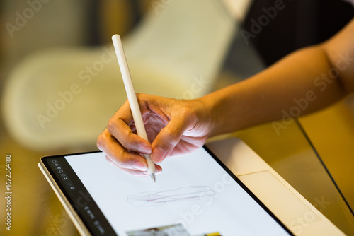 close up of the hand of a business woman holding an ipad at work
