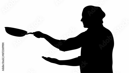 Silhouette of a chef tossing food in a frying pan with one hand and catching with the other hand in kitchen
