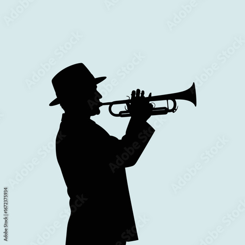 Silhouette of a person playing a trumpet against a light blue background.