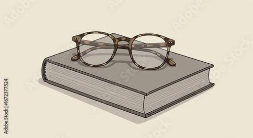 Eyeglasses Resting on Book Cover on Surface