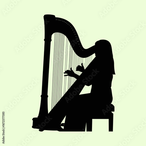 Silhouette of a person playing a harp against a light background.