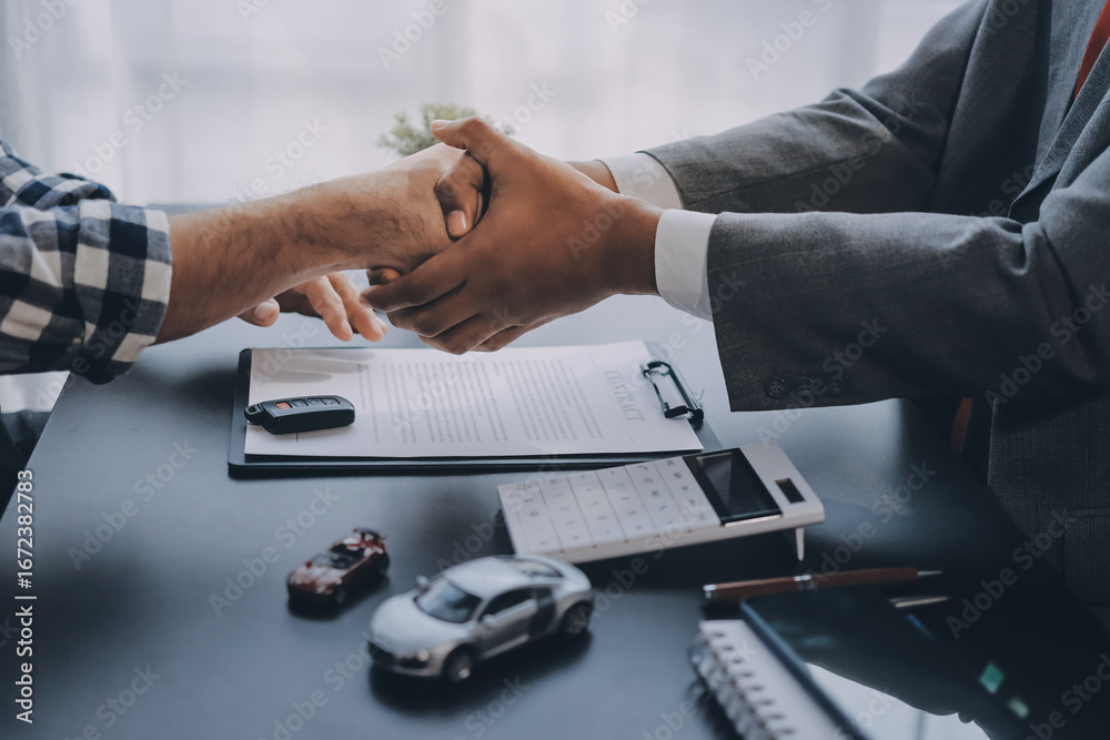 Fototapeta premium Car salesman gave the keys to the customers who signed the purchase contract legally, Successful completion of car sales, Purchase contract and key delivery.