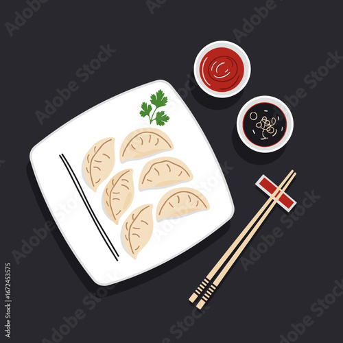 Delicious pan fried dumplings served with soy sauce and chili ketchup for a perfect meal