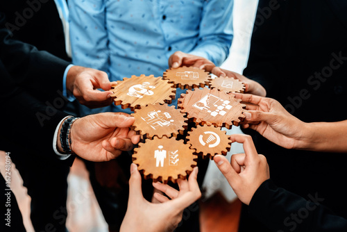 A diverse group of professionals collaborates over symbolic gears, representing various management strategies and innovative business concepts in a dynamic setting. Amity