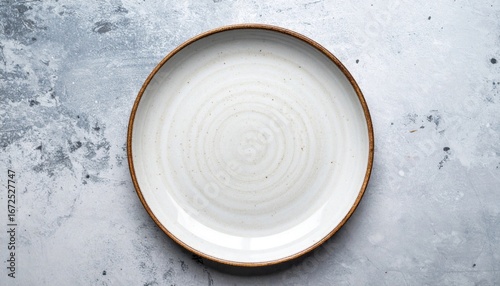 Close Up Overhead Shot of a White Ceramic Plate on a Gray Textured Background