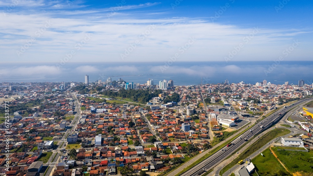 Fototapeta premium Aerial cityscape of Barra Velha with BR-101 highway and coastline view.