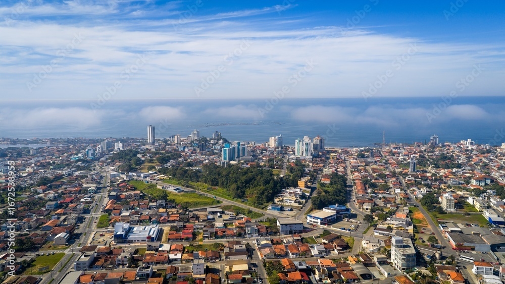 Obraz premium Panoramic aerial view of Barra Velha city with low mist over the coast.